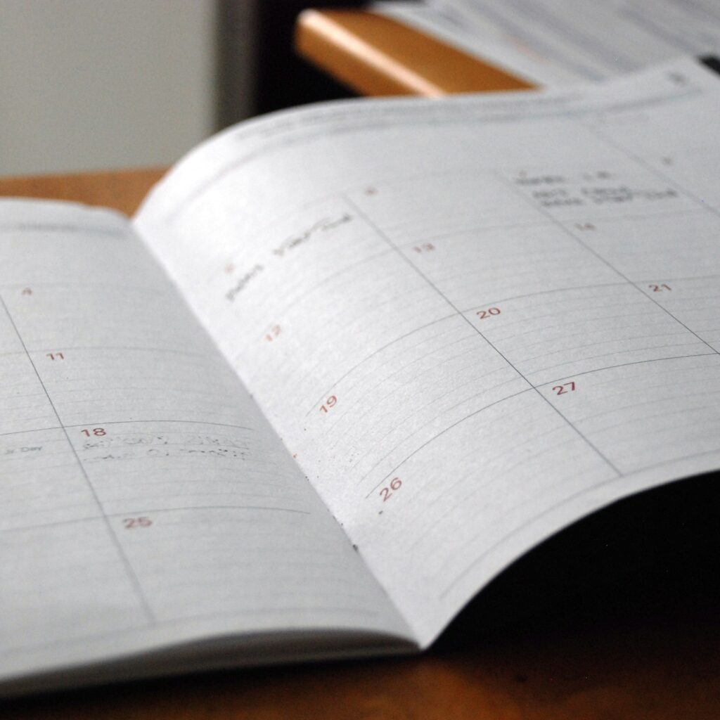 Open monthly planner on a wooden desk