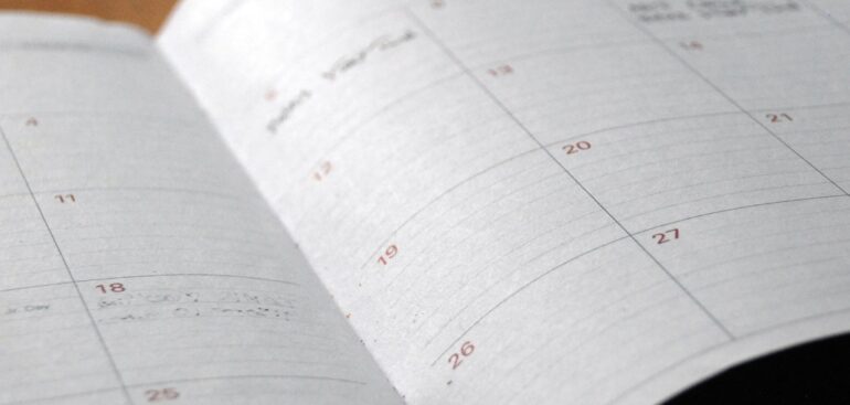 Open monthly planner on a wooden desk