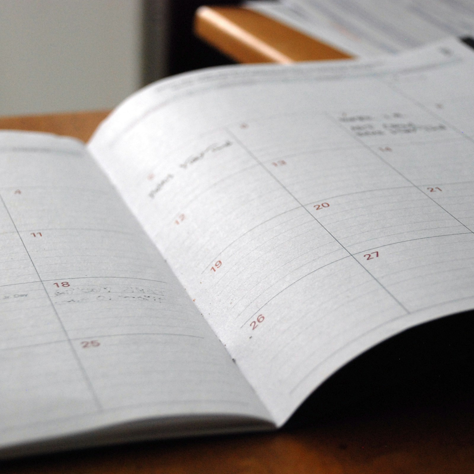 Open monthly planner on a wooden desk