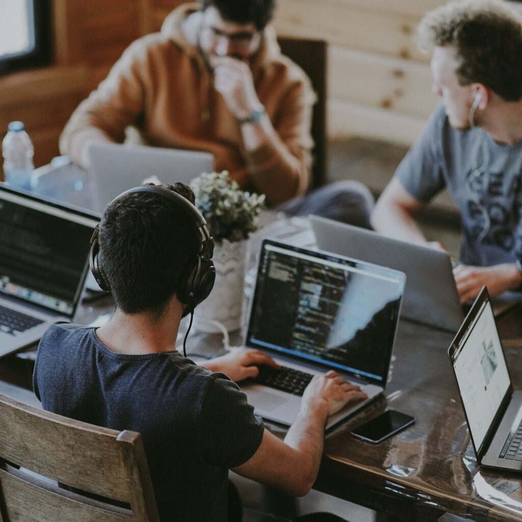 Small team working on laptops in a shared office