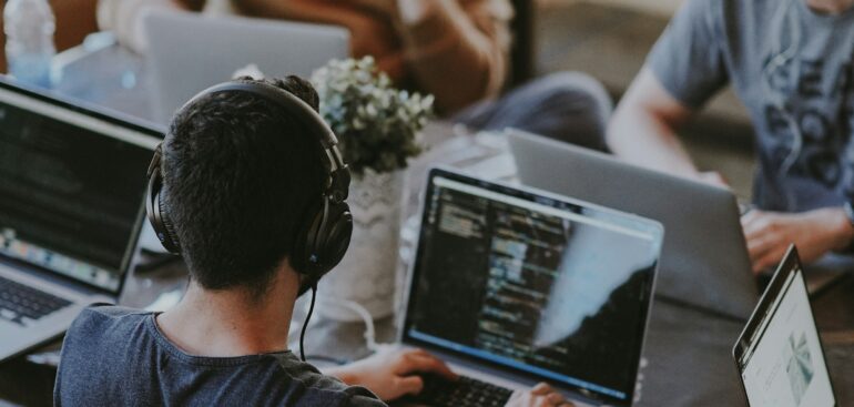 Small team working on laptops in a shared office