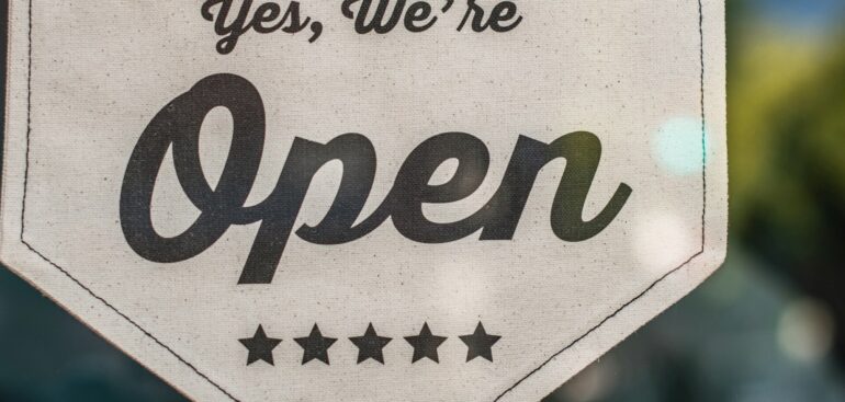 Yes, we're open sign hanging in a shop window