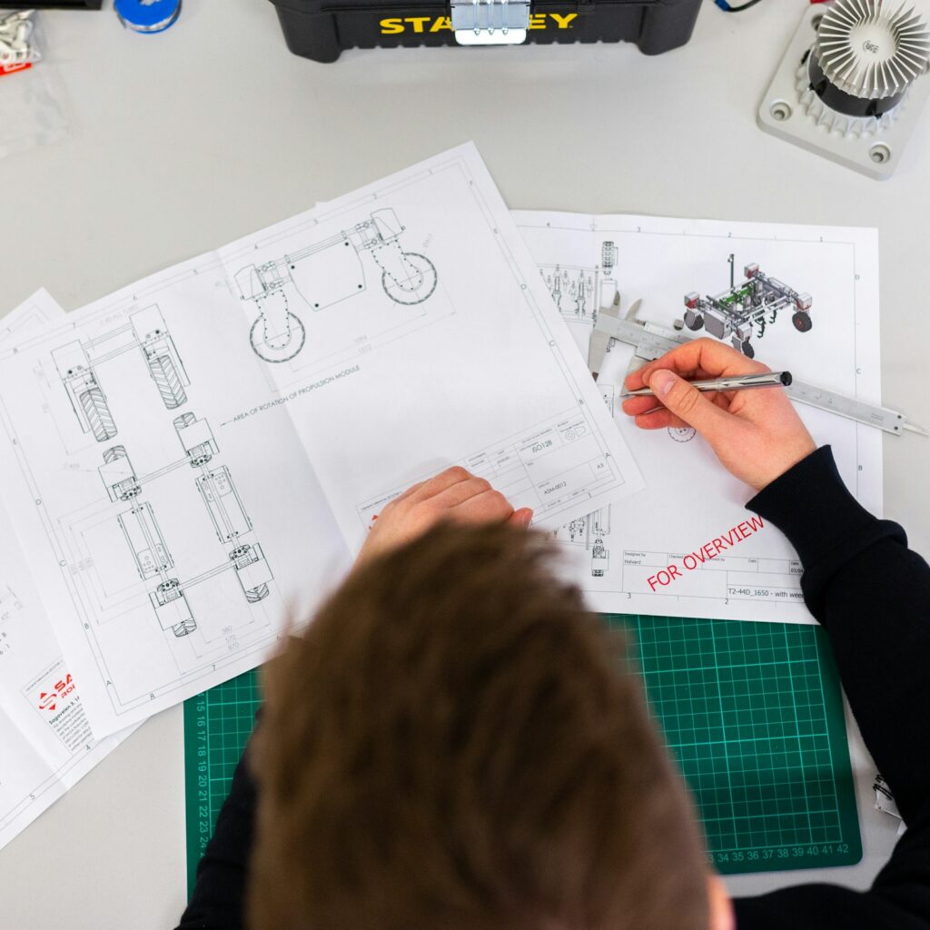 Engineer sketching product designs on a workbench