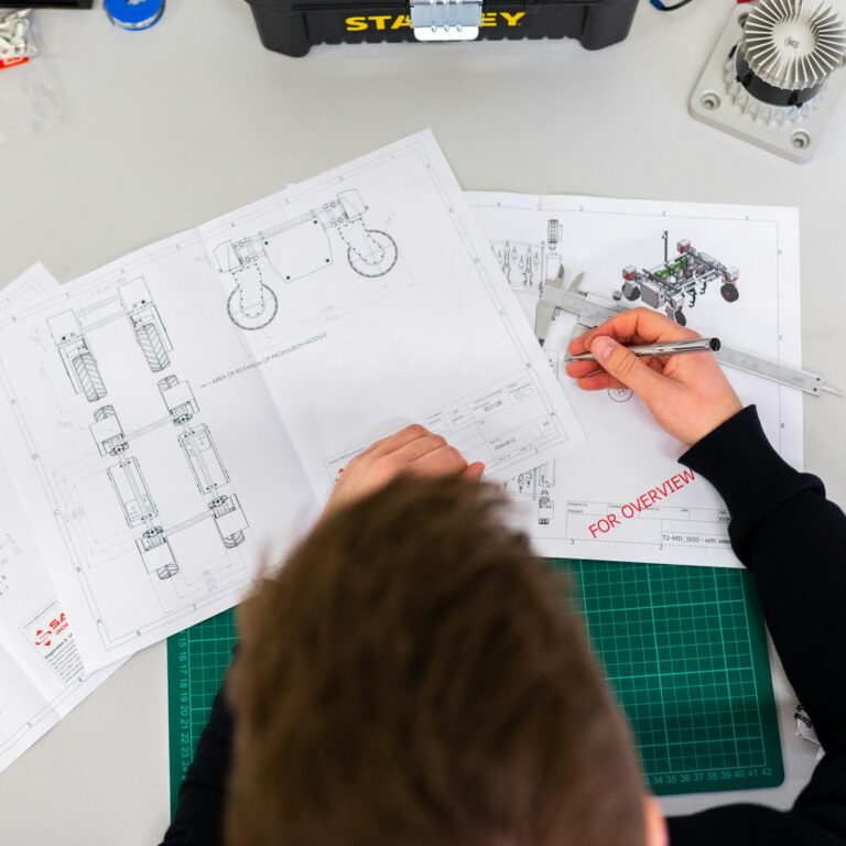 Engineer sketching product designs on a workbench