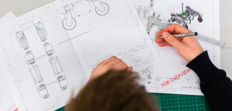 Engineer sketching product designs on a workbench