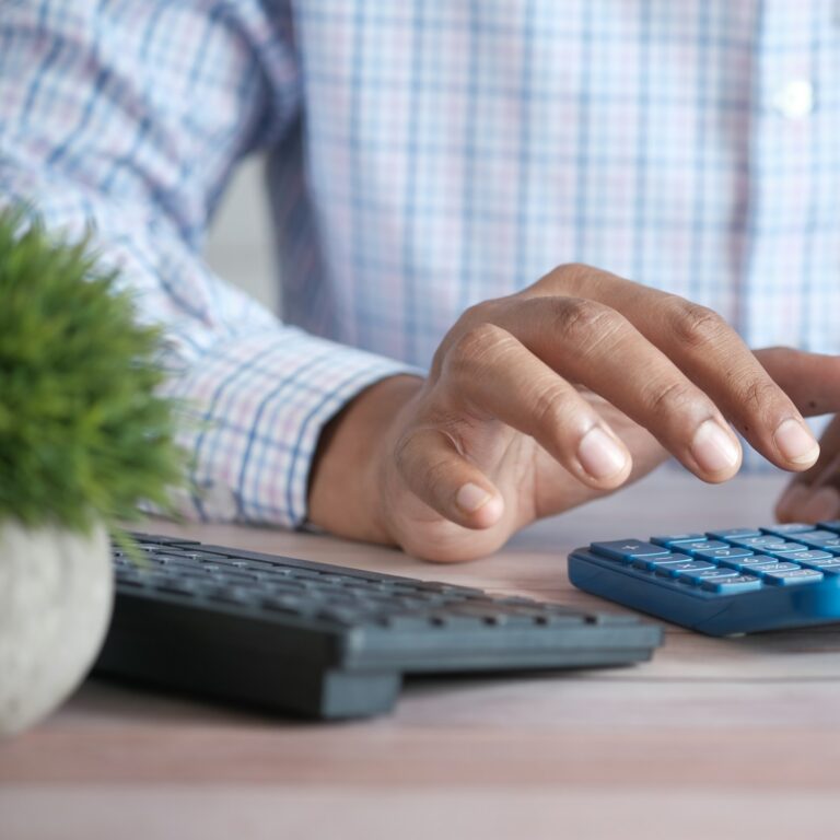 Business owner working through GST/HST figures on a calculator
