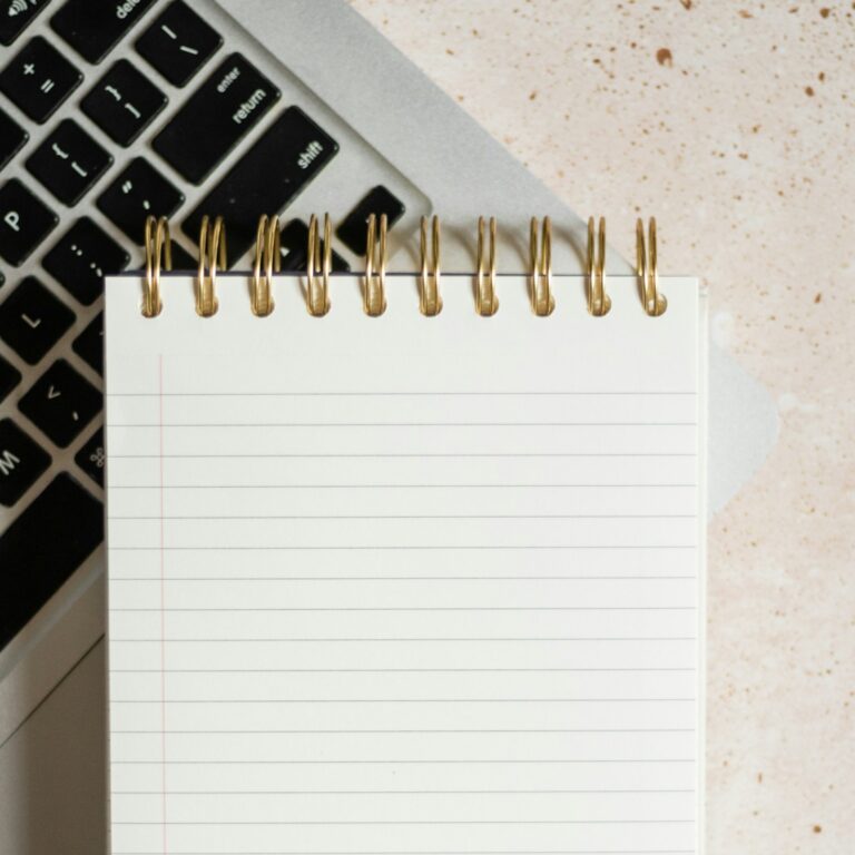 Laptop, notepad and calendar laid out for year-end planning