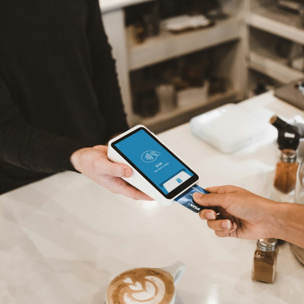 Customer paying by card at a cafe payment terminal