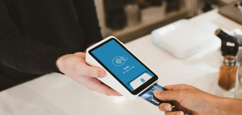 Customer paying by card at a cafe payment terminal