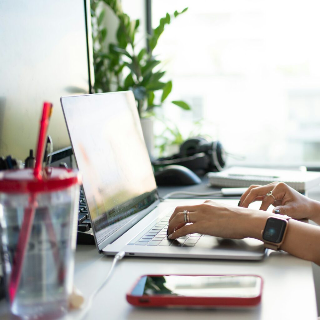 Independent consultant working on a laptop at a desk