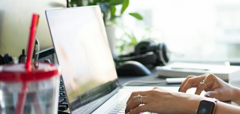 Independent consultant working on a laptop at a desk